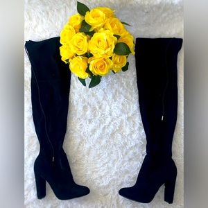 Black over the knee heeled boots.